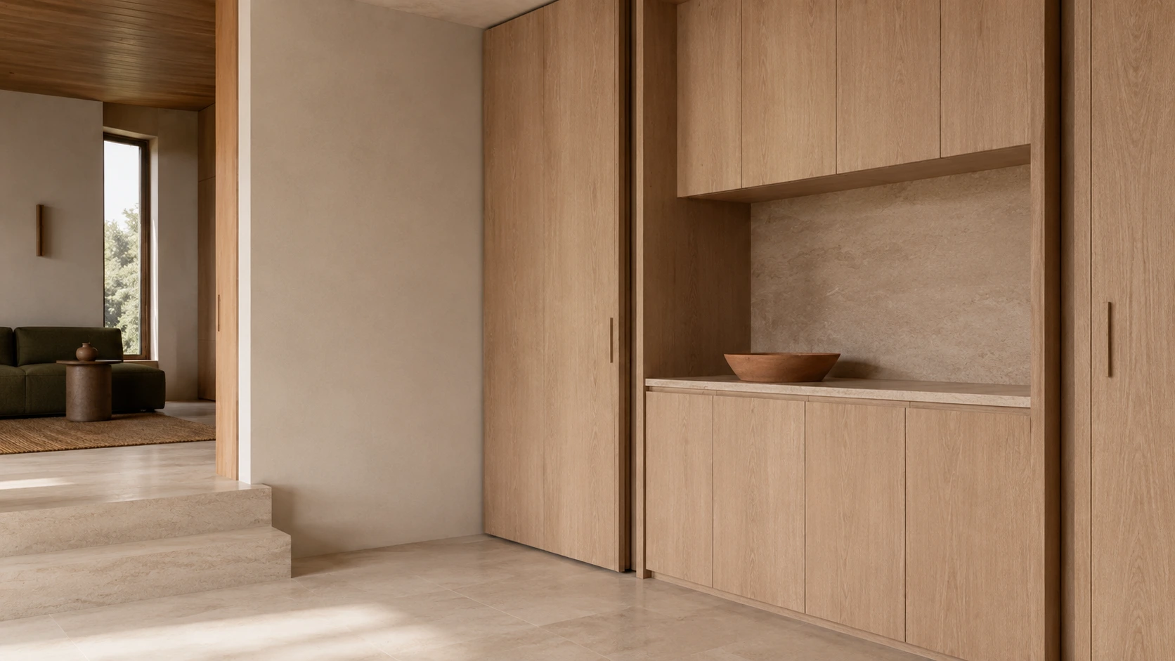 Continuous pale oak cabinetry with flush doors and a stone-lined display niche beside the stepped living-room transition.